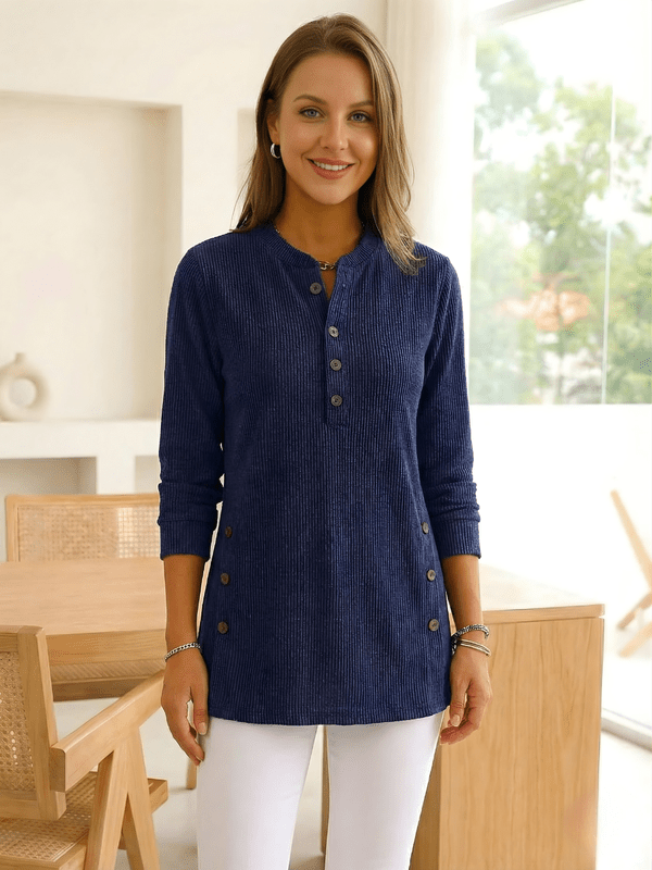 Woman wearing a navy long-sleeve buttoned tunic top.