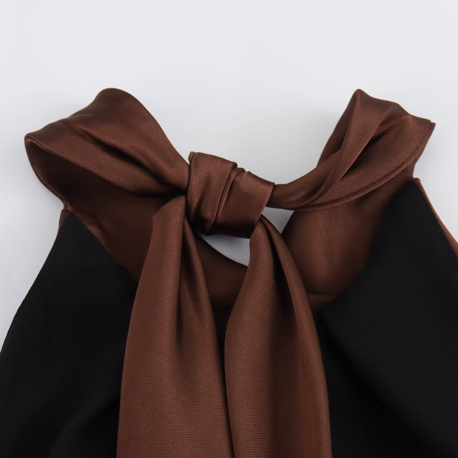 Close-up of the brown halter neck tie bow.